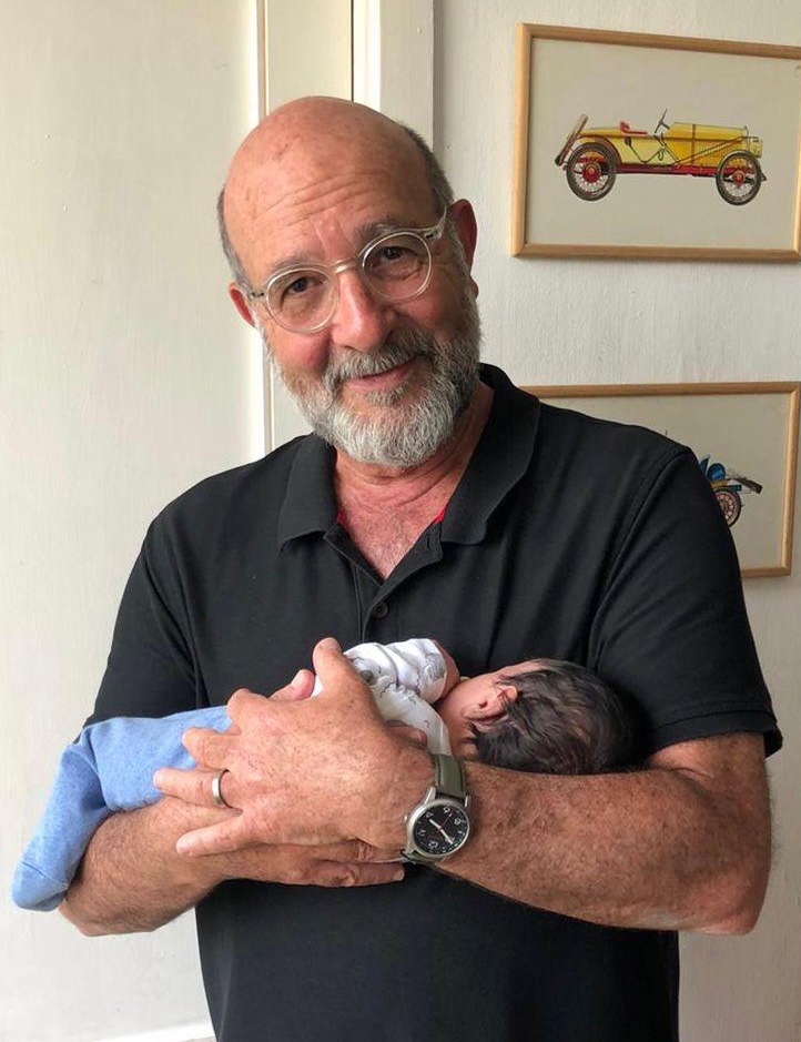 David Senesh holding his newborn grandchild